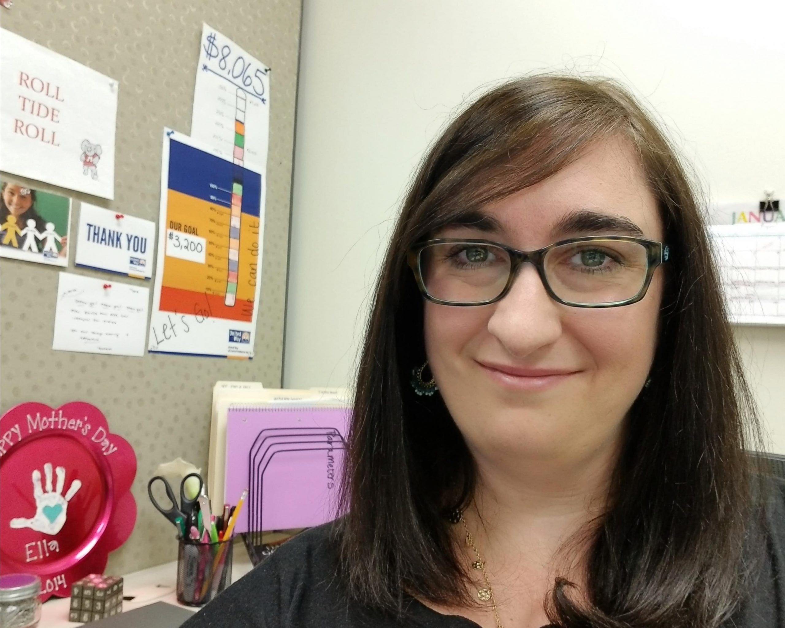 Maria Gilbert smiling at her CRST office workspace, sharing her experience on why CRST is a great place to work.