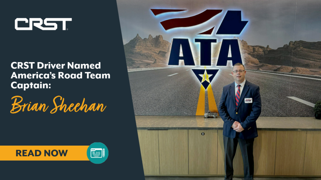 Road Team Captain Brian Sheehan standing in front of ATA sign with navy suit on.