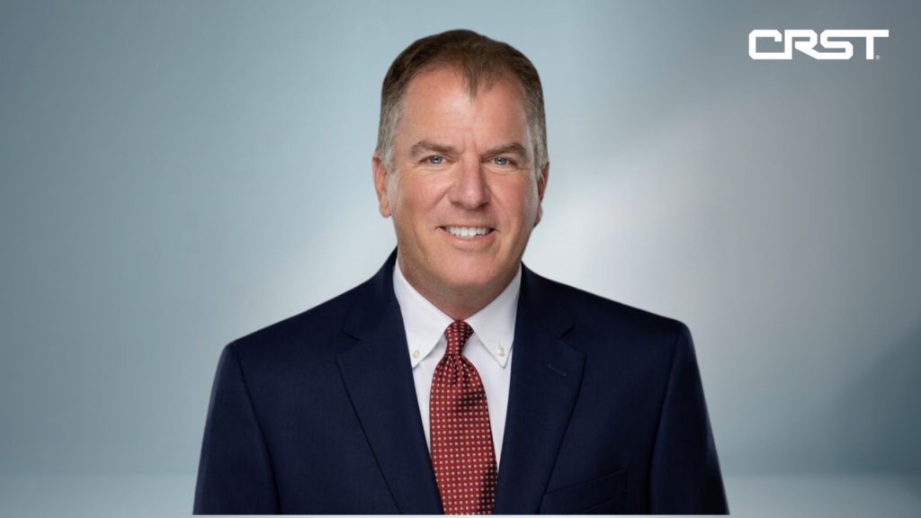 Professional headshot of Bill Clement, newly appointed Group President & Chief Strategy Officer at CRST, wearing a navy suit, white shirt, and red tie, with the CRST logo in the top right corner.